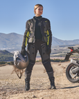 Woman motorcyclist on a gravel road wearing textile motorcycle set 