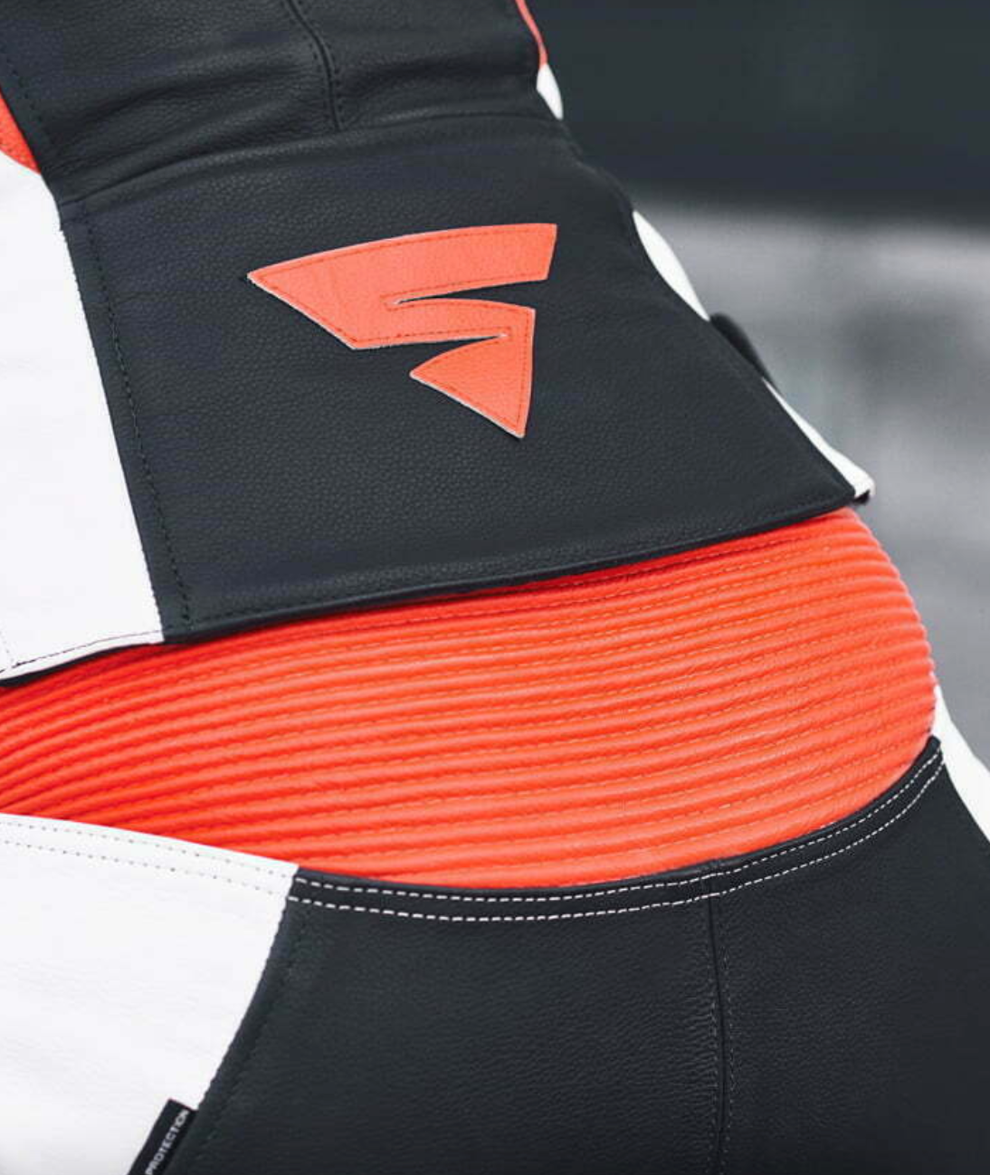 Shima logo on a back of black, white and red fluo leather motorcycle suit