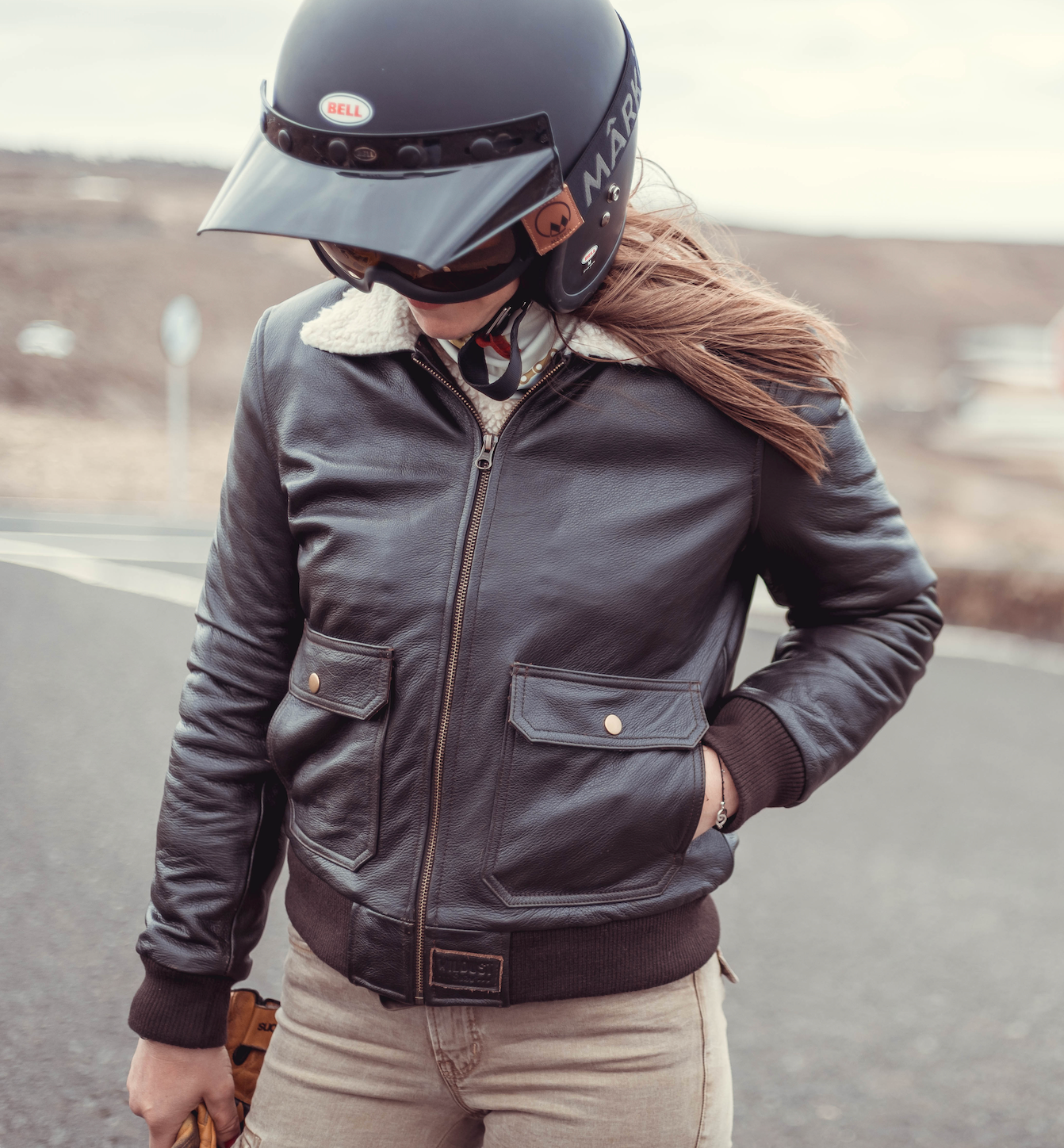 woman motorcyclists wearing brown aviator style jacket