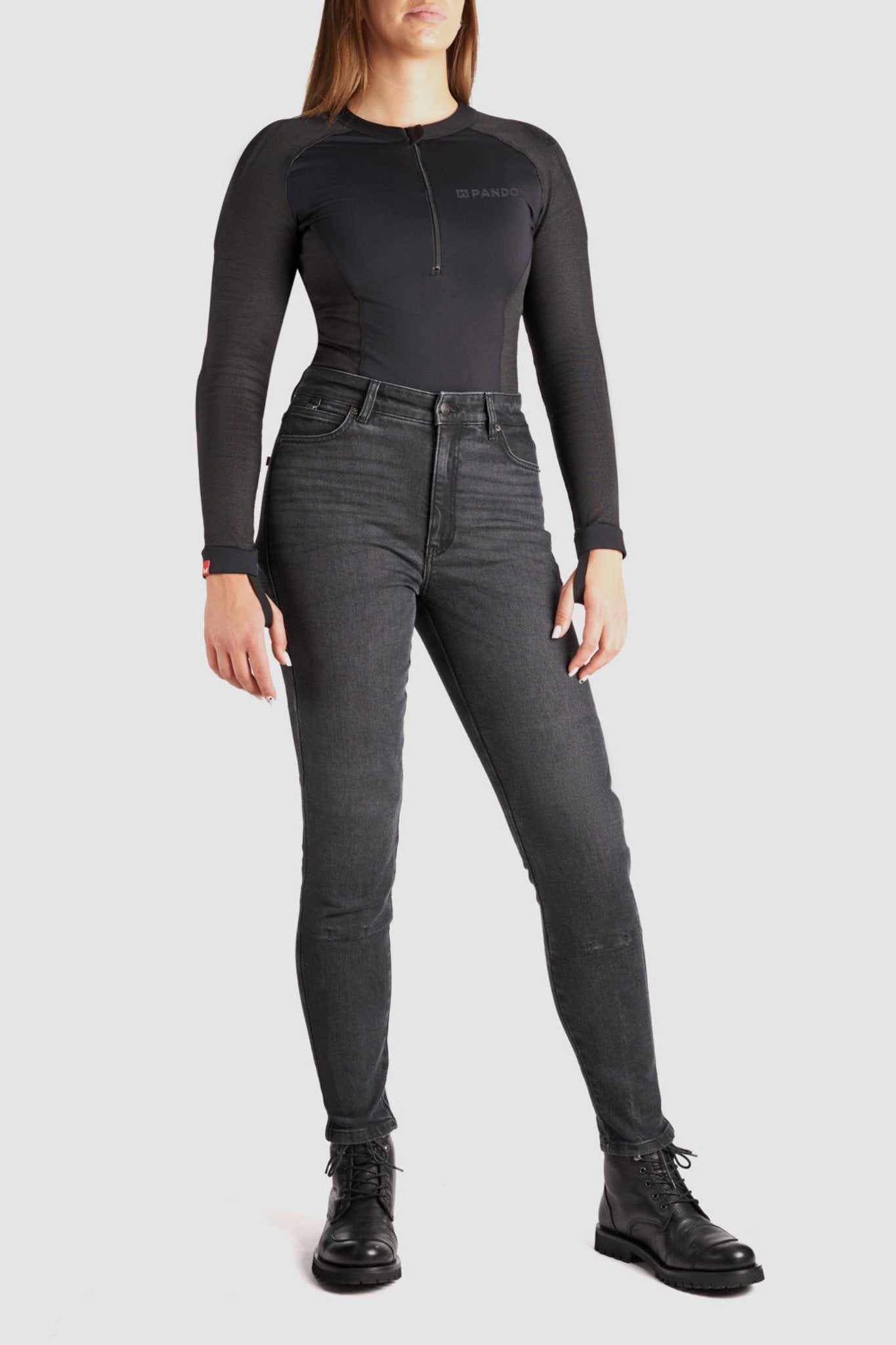 a woman wearing black jeans and black motorcycle body suit from Pando Moto 