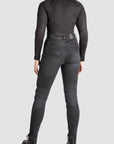 a woman back wearing black jeans and black motorcycle body suit from Pando Moto 