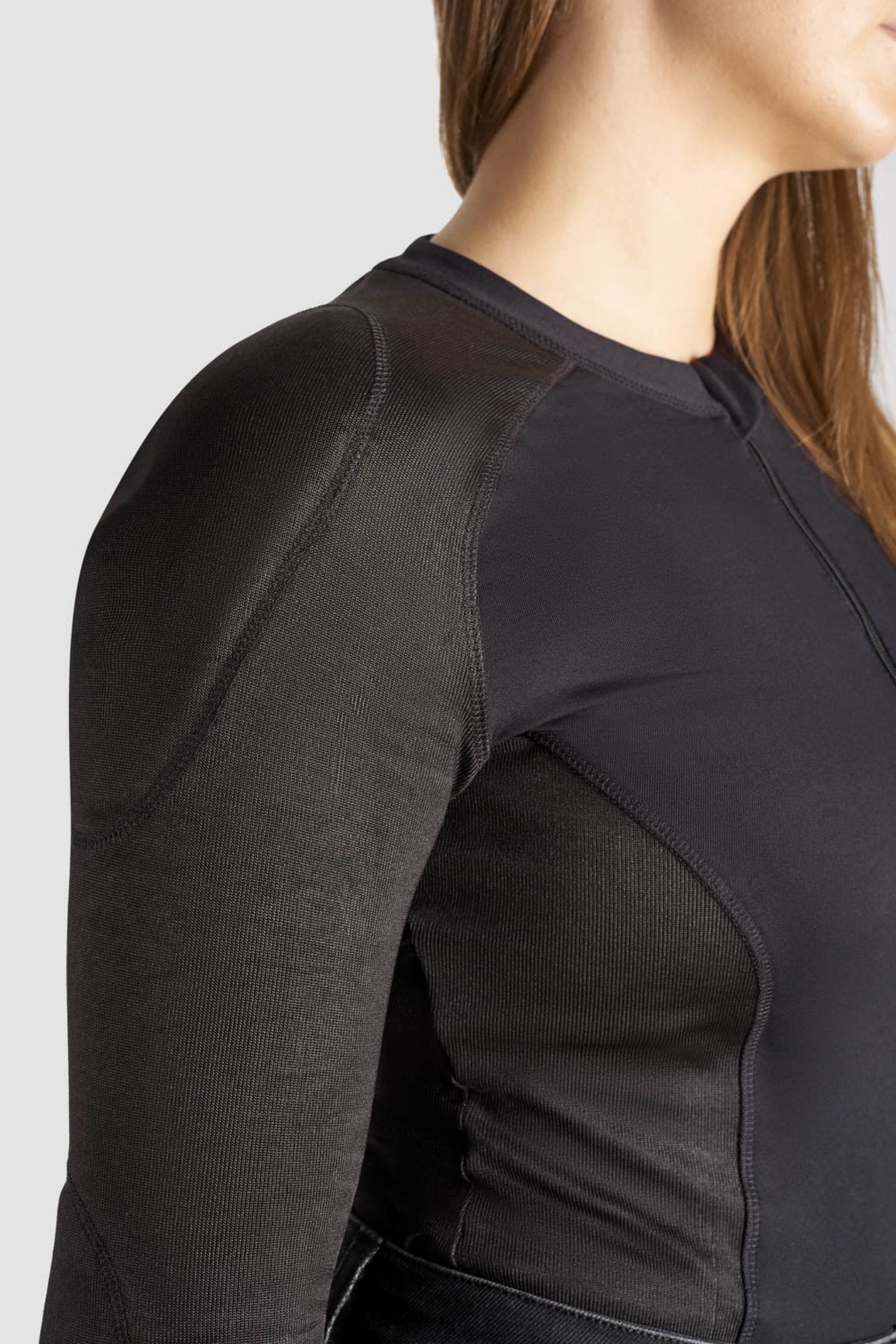 a close up of woman&#39;s shoulder wearing black motorcycle body suit from Pando Moto 