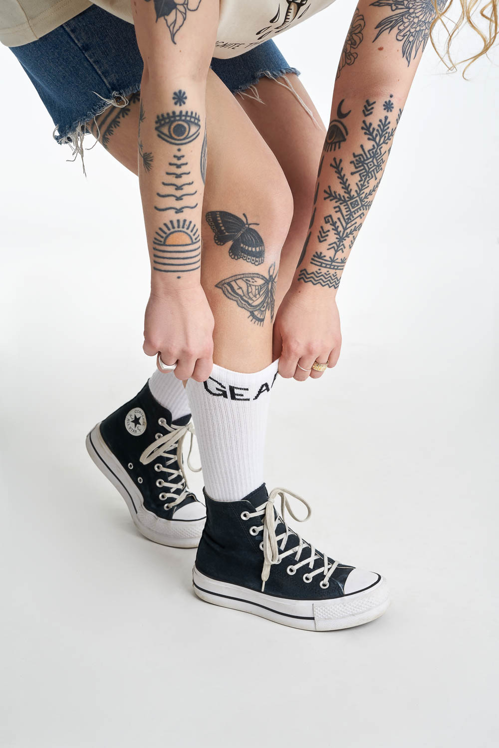 Women&#39;s legs wearing white socks with  &quot;gear&quot; motive