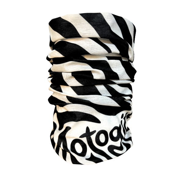 A black and white zebra-print neck gaiter with the word 'motogadget' printed in a stylized black font on the lower portion, shown against a plain white background.