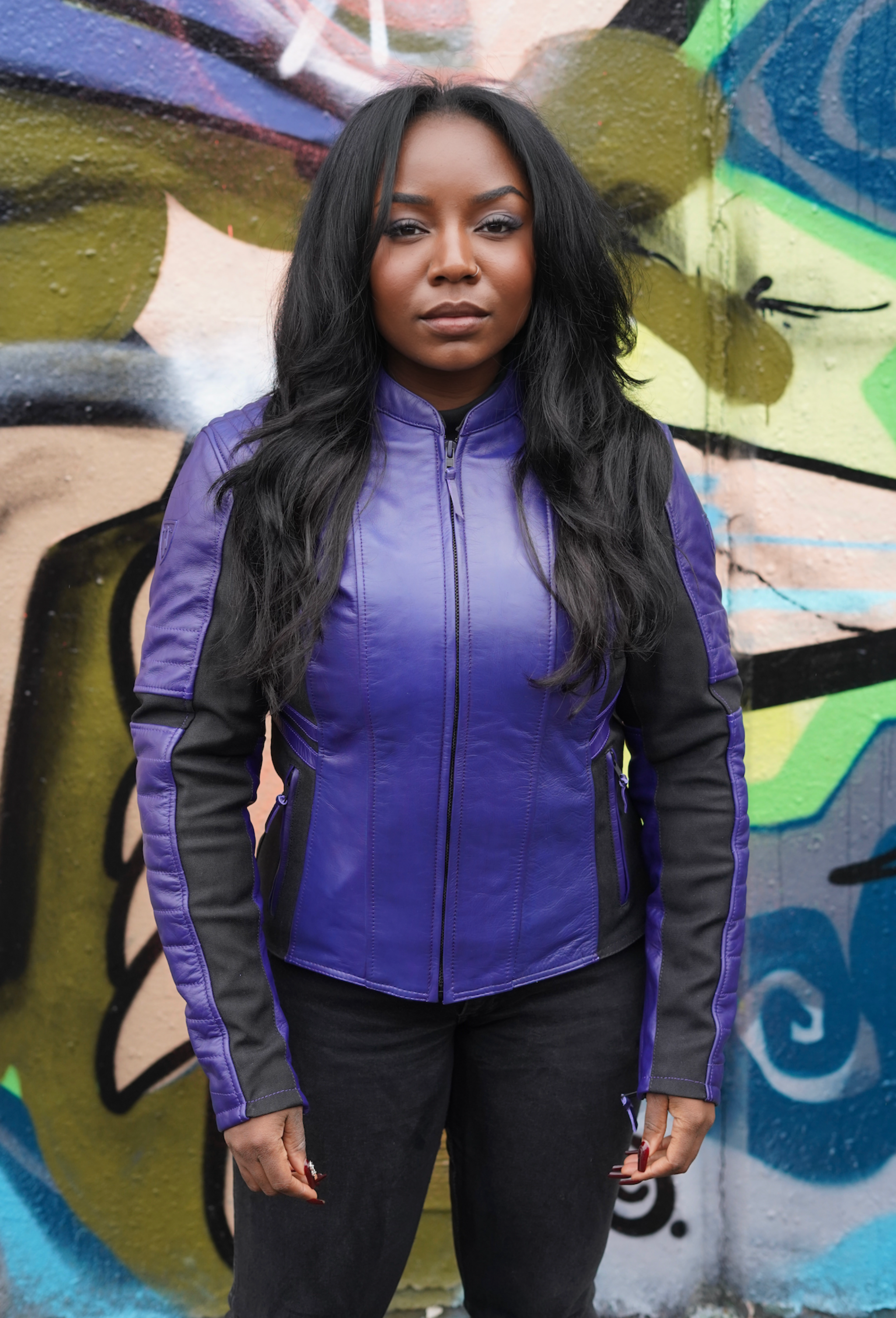 a black woman wearing purple motorcycle leather jacket for women with front zipper 