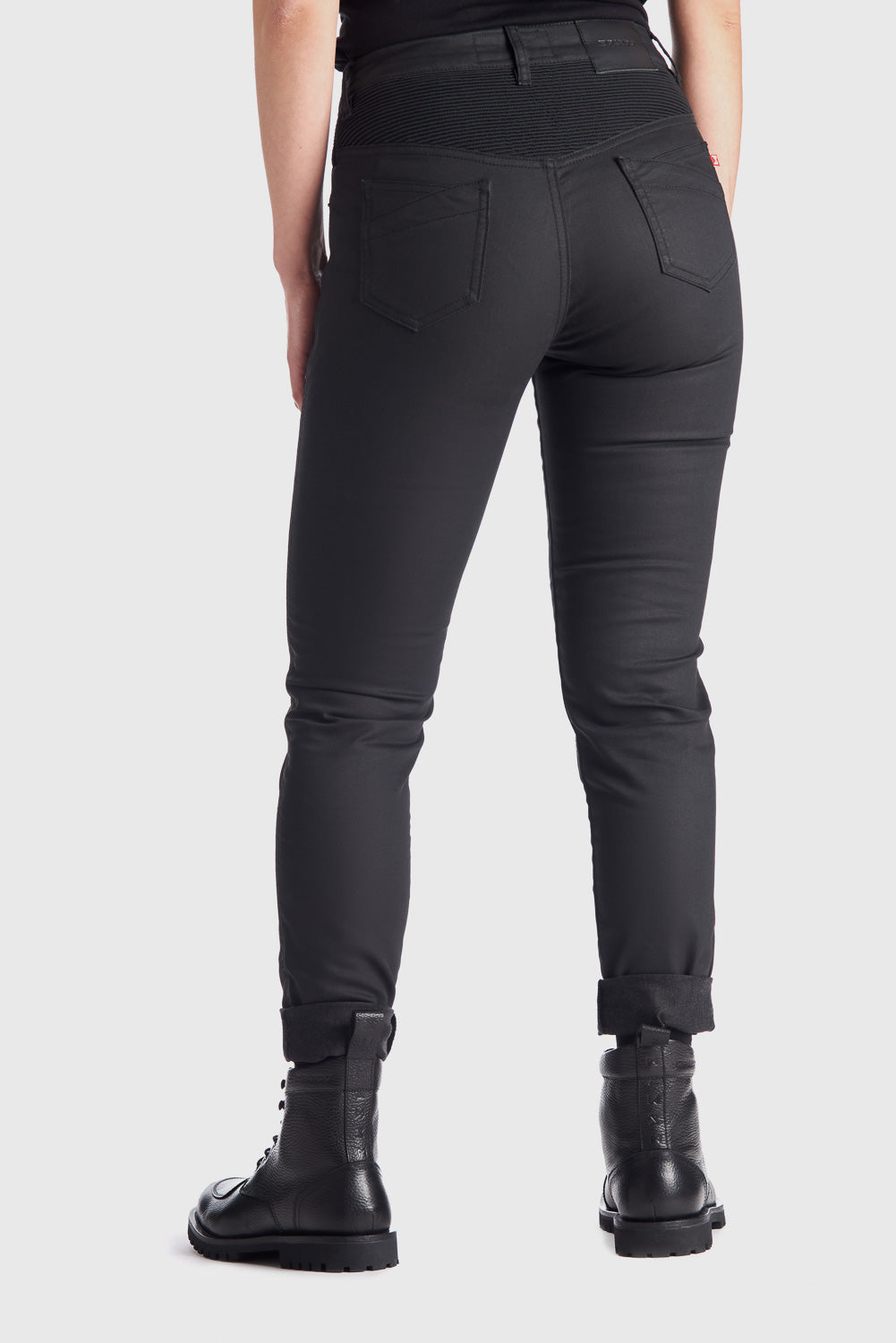 The back of woman's legs wearing slim-fit motorcycle jeans from Pando Moto 