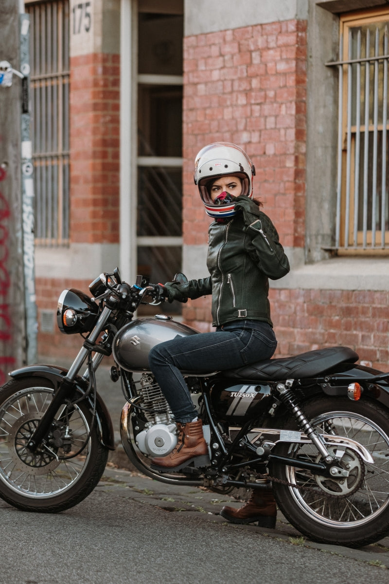 A woman on her motorcycle wearing brown leather mc shoes