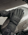 A woman on a Harley Davidson motorcycle wearing black Nandi winter motorcycle gloves from Motogirl.