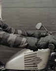 A blond woman on a Harley Davidson motorcycle wearing black Nandi winter motorcycle gloves from Motogirl.