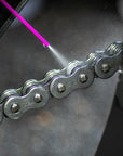 motorcycle chain being sprayed with the muc-off Dry chain lube for motorcycles and scooters