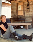 A woman siting on the ground and wearing grey MotoGirl female motorcycle jeggings  