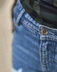 A close up of the key chain hole on the waist of blue motorcycle jeans