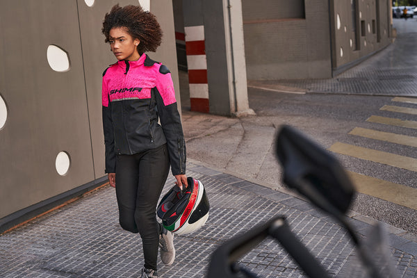 A young woman pink DRIFT  motorcycle jacket from Shima