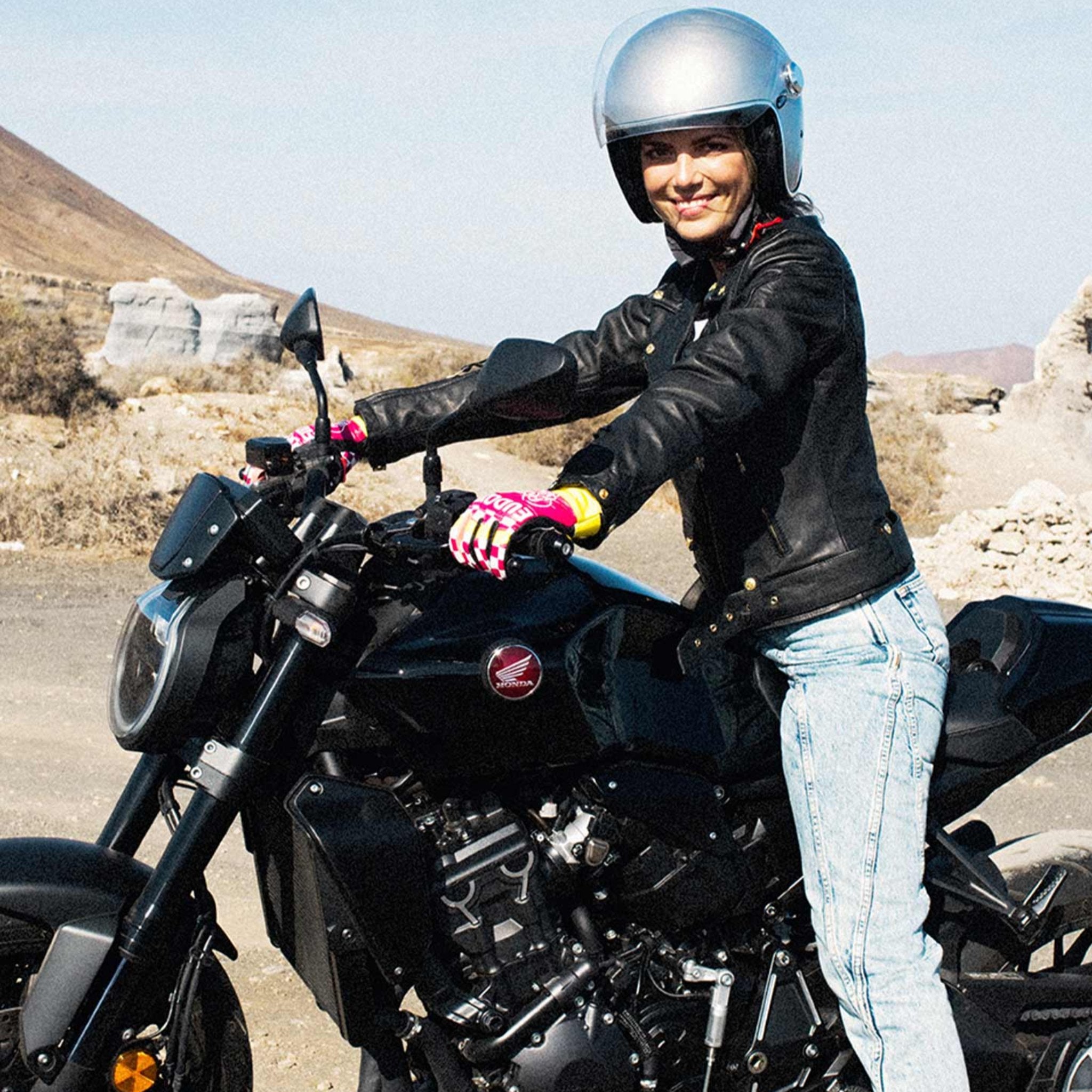 A young woman on a motorcycle wearing Classic retro black women&#39;s motorcycle jacket from Eudoxie