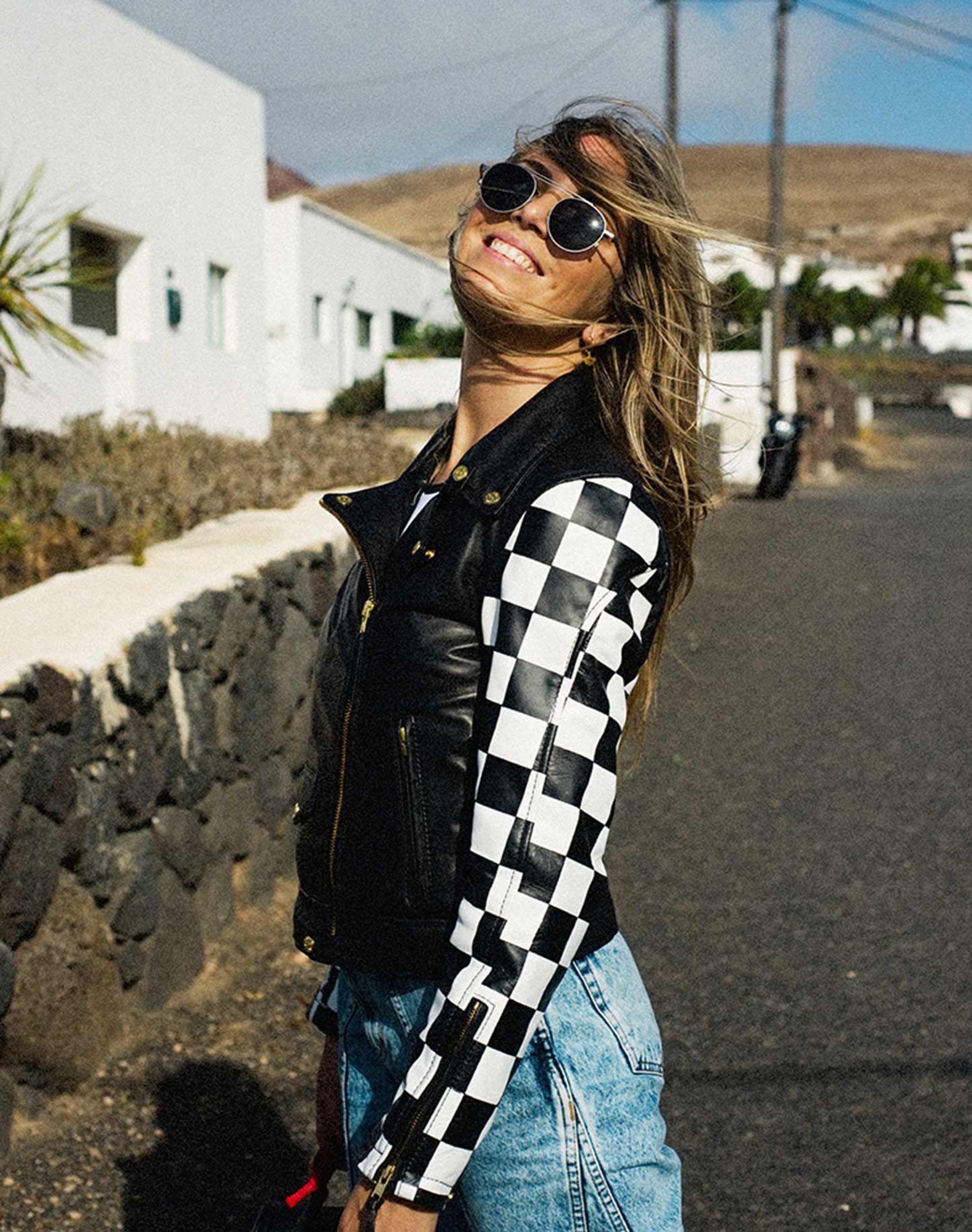 a young blond woman wearing chessboard design mc jacket