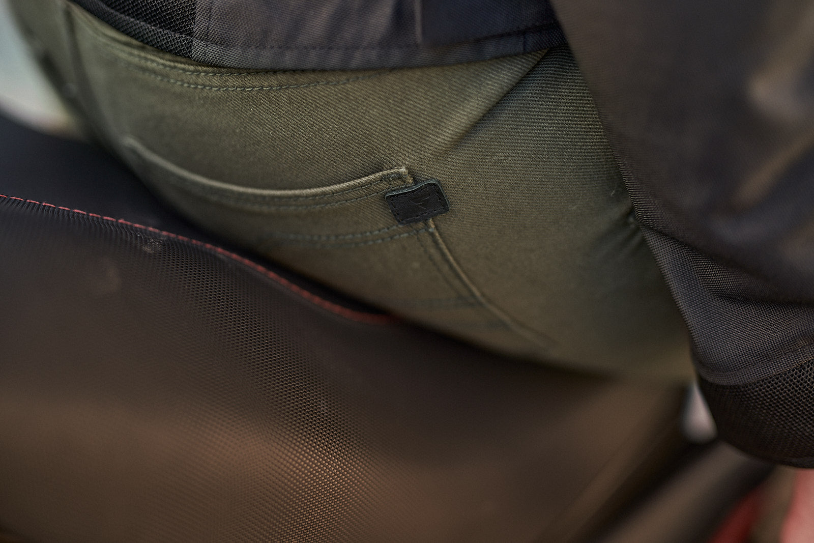 A close up of the back pocket of Khaki green women&#39;s motorcycle pants