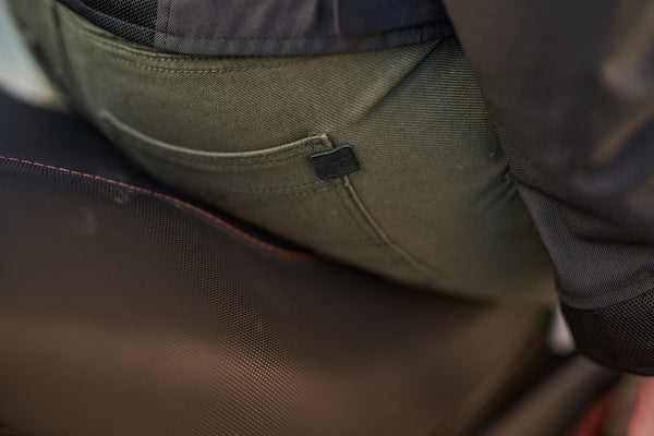 A close up of the back pocket of Khaki green women's motorcycle pants