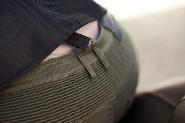 A close up of the back waist area of a woman wearing Khaki green women's motorcycle cargo pants GIRO from shima