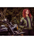 A women standing in front of a motorcycle wearing Women's motorcycle summer mesh jacket in black and green from Moto Girl