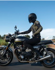 A woman on a motorcycle wearing women's motorcycle summer mesh jacket in black and green from Moto Girl