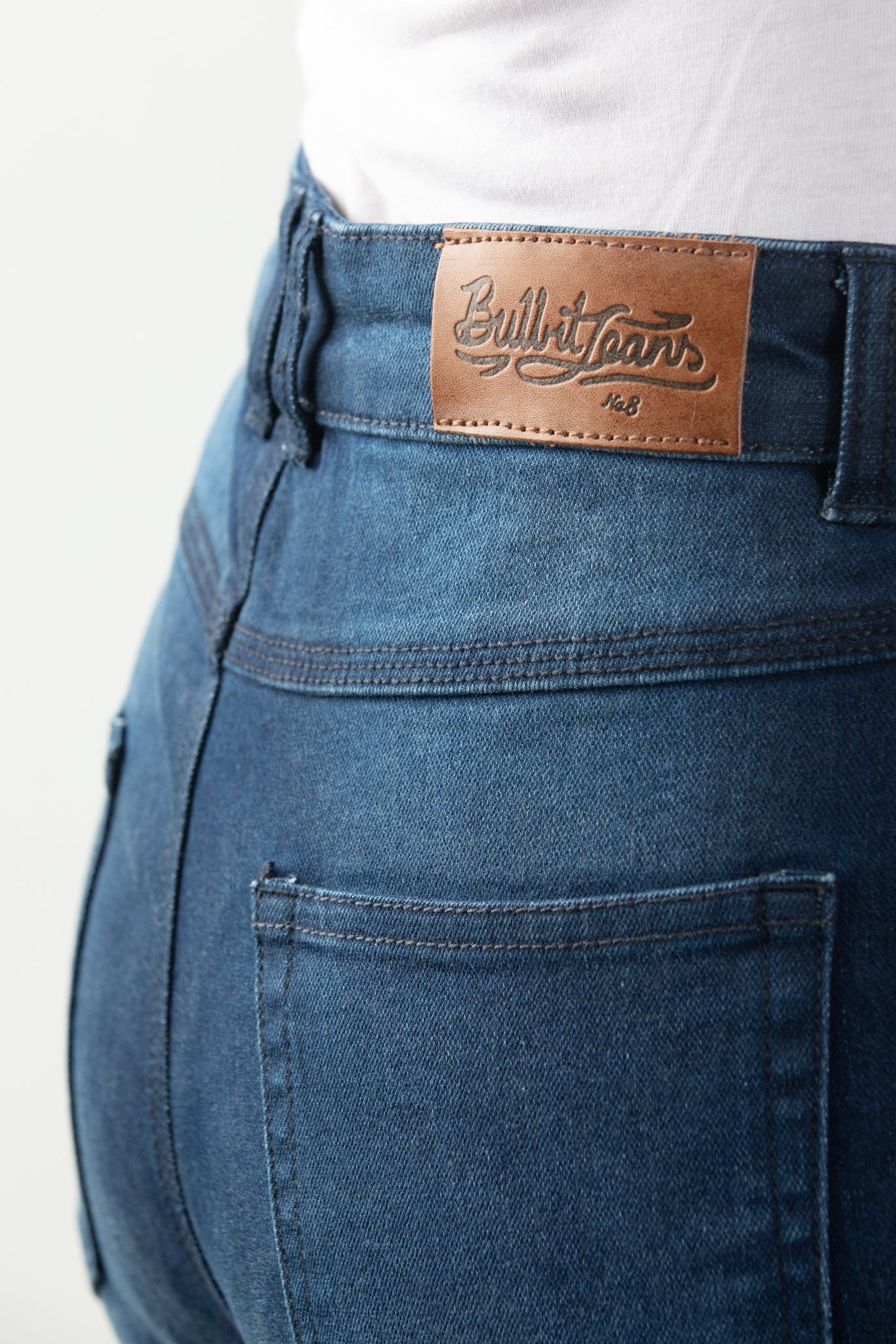 Close up of woman&#39;s waist wearing lady blue motorcycle jeans