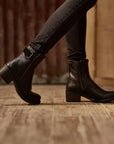 Woman wearing women's black leather motorcycle shoes 
