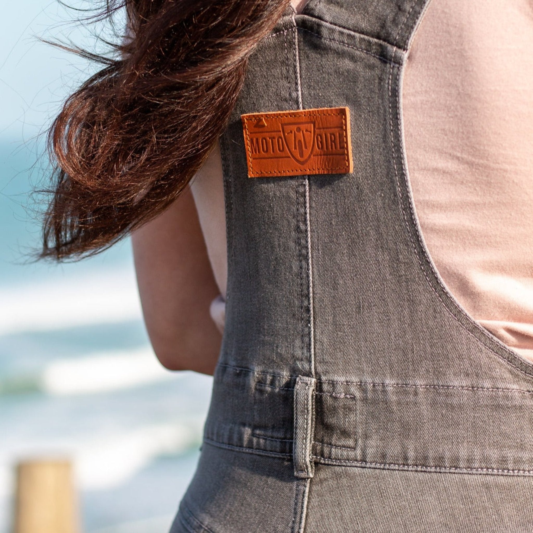 A close up of the Moto Girl patch on the back of women's motorcycle overall 