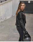 A blond woman wearing Black leather motorcycle jacket for women from Shima