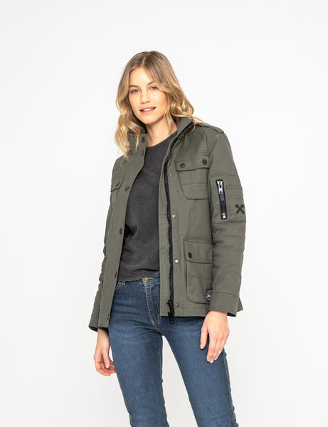 A woman wearing blue mc jeans and a olive green army style lady motorcycle shirt from john doe