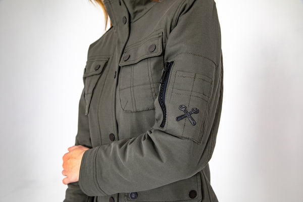 A close up of the chest and sleeve of olive green army style lady motorcycle shirt from john doe