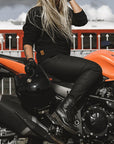 A blond woman on a motorcycle wearing women's black motorcycle jeans Lorica Kevlar from Pando Moto