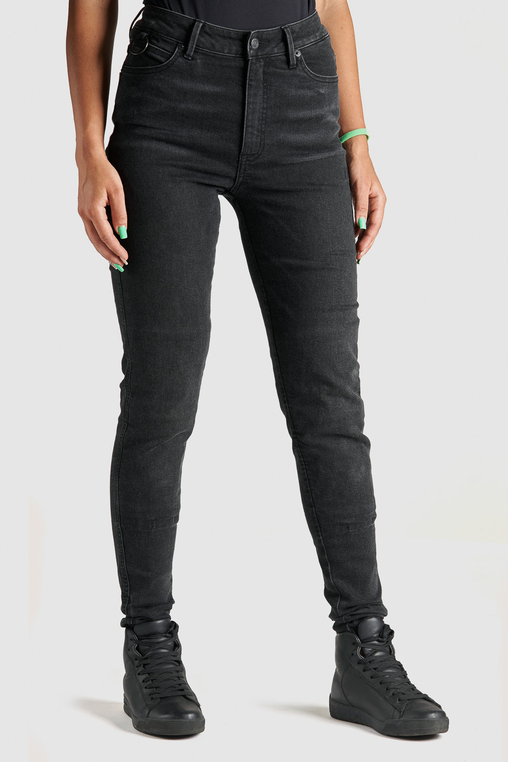 woman's legs wearing black high waist motorcycle jeans