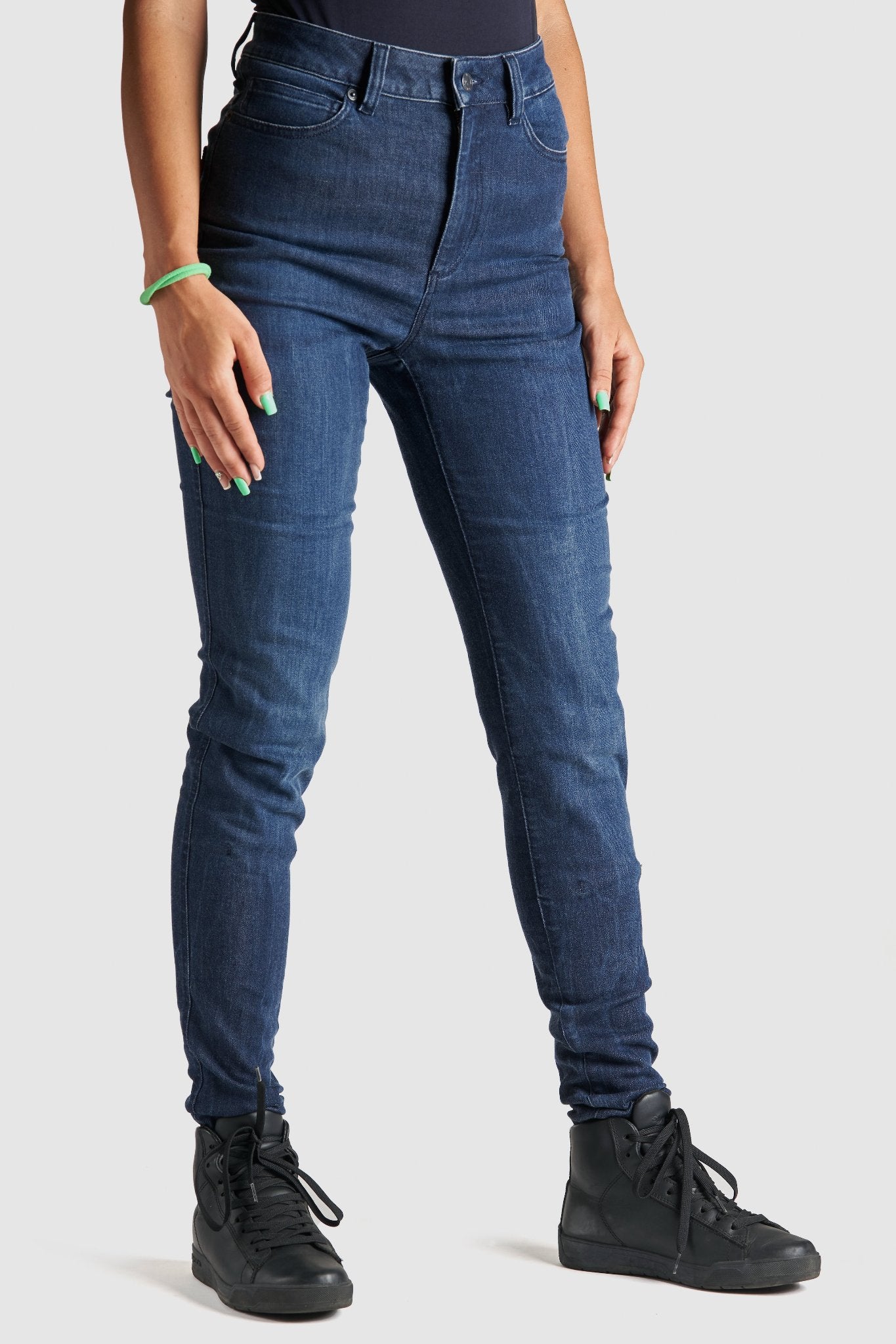 Woman's legs wearing blue motorcycle jeans 