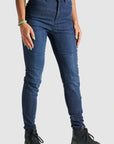 Woman's legs wearing blue motorcycle jeans 