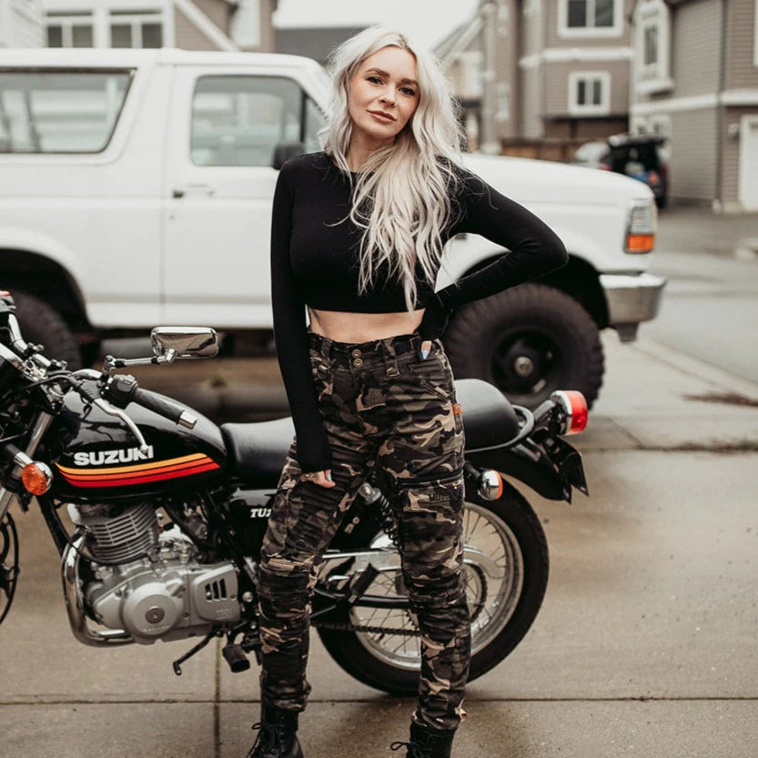 A young blond woman wearing women camouflage motorcycle cargo pants from Moto Girl  