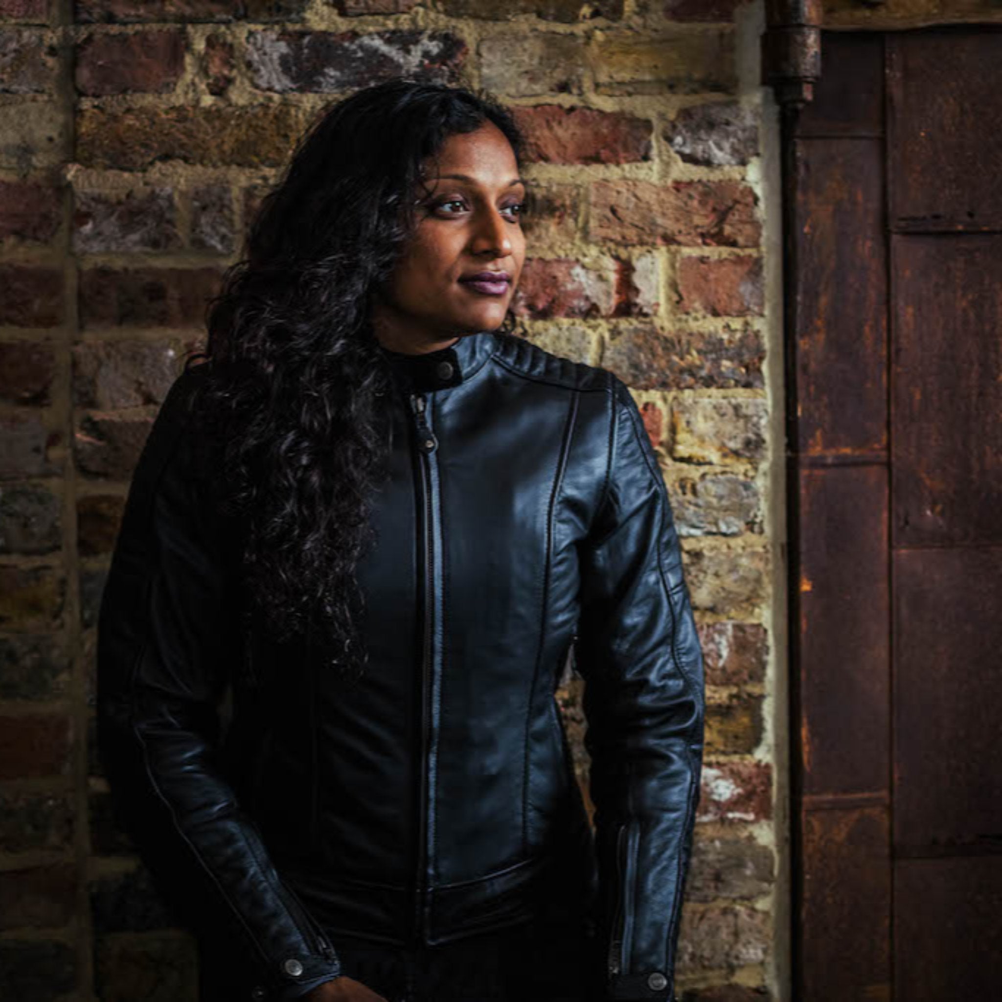 black haired woman wearing black leather jacket from moto girl