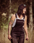 A woman in the field wearing black motorcycle overall from MotoGirl