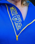 A blond woman wearing blue and yellow motorcycle hoodie