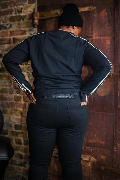 A woman wearing black leggings and sweatshirt