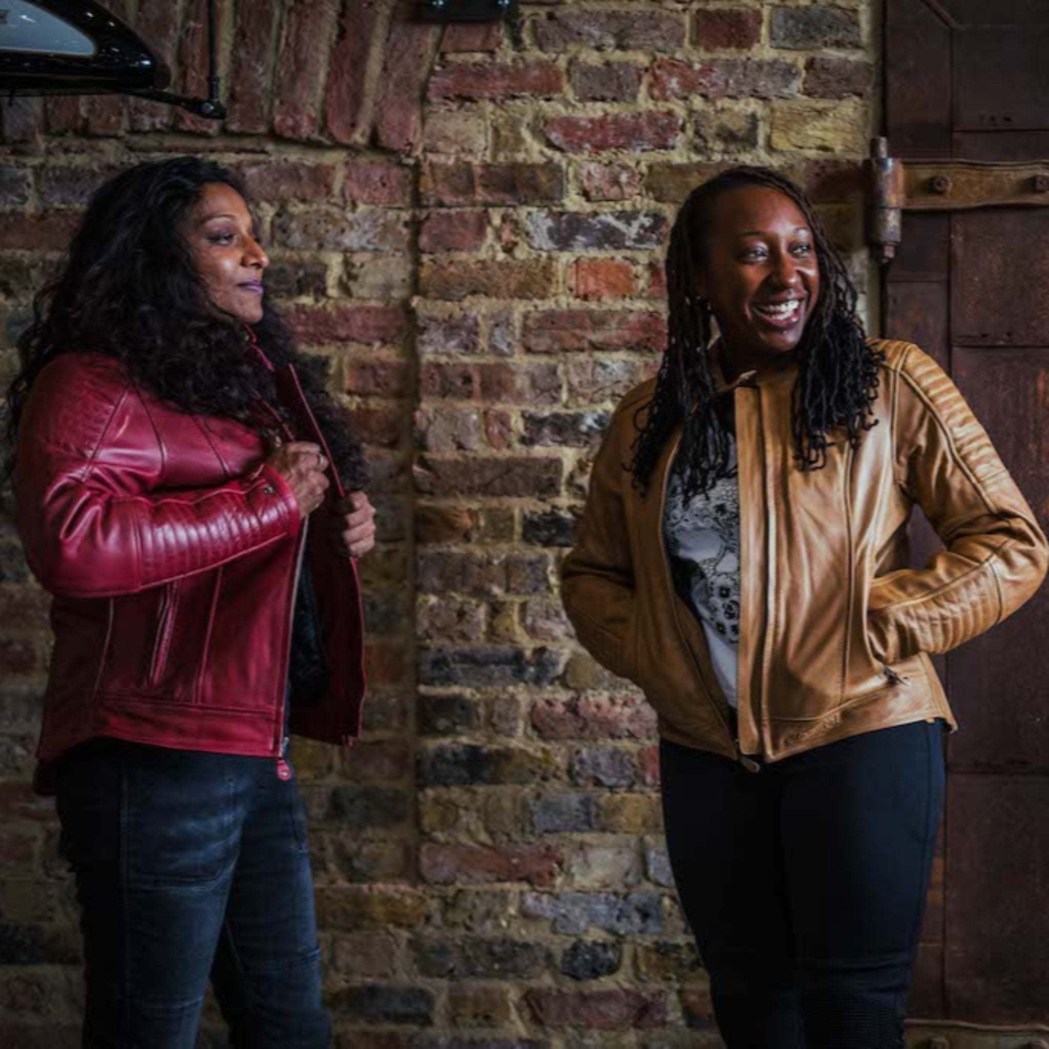 Women in a garage wearing red Valerie motorcycle leather jacket from Moto Girl