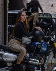 a woman on her motorcycle wearing beige mc pants 
