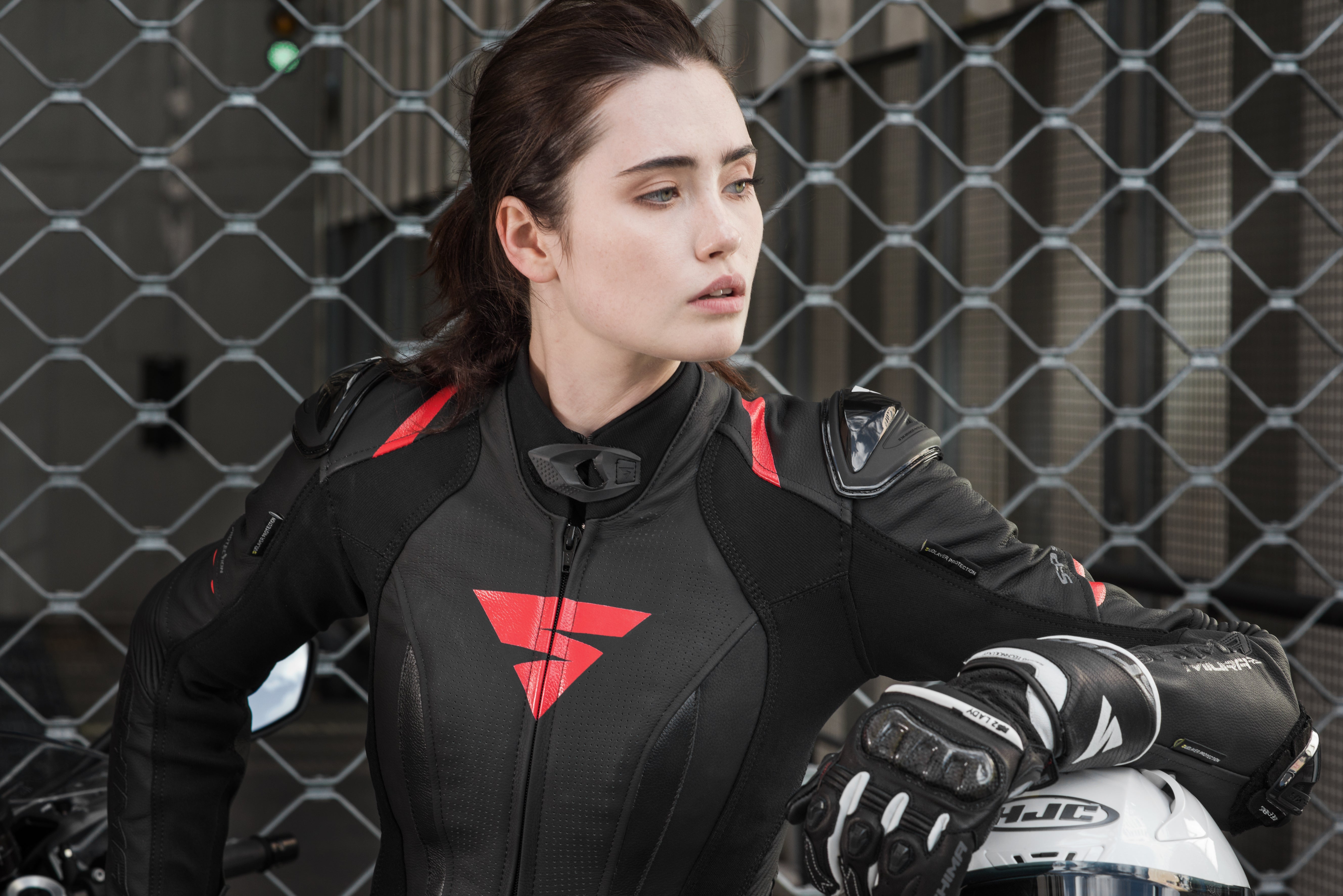 A young woman wearinh Black and red women&#39;s motorcycle racing suit from Shima