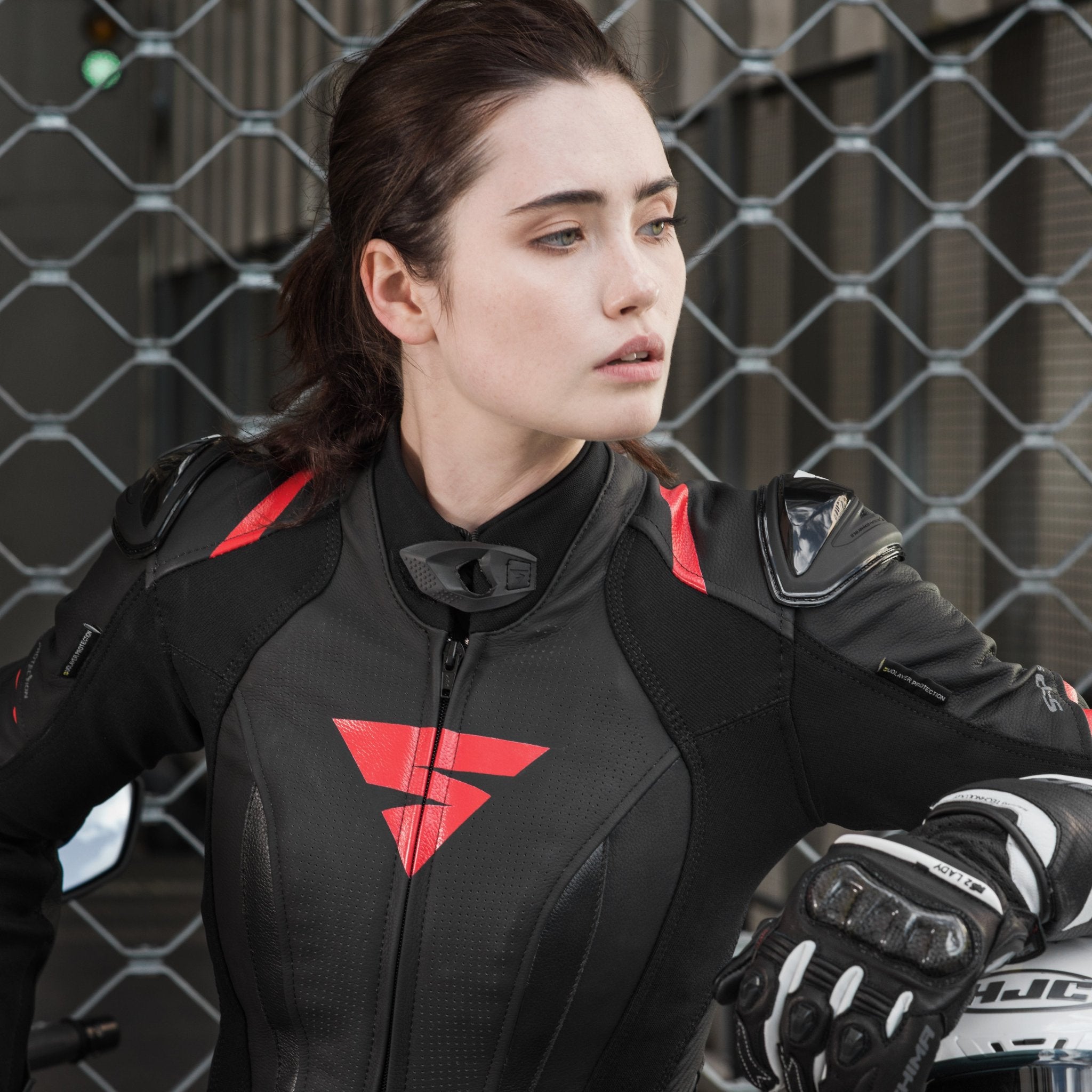 A young woman wearinh Black and red women's motorcycle racing suit from Shima