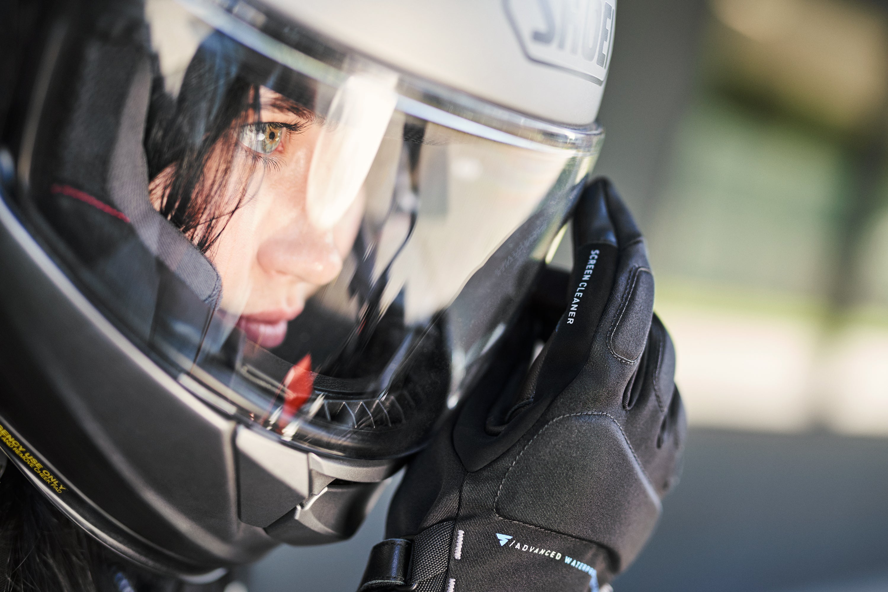 the close up of the woman&#39;s face wearing a moorcycle helmet