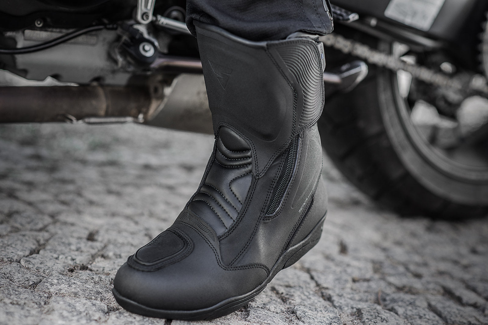Woman&#39;s foot with a black women&#39;s motorcycle touring boot from Shima