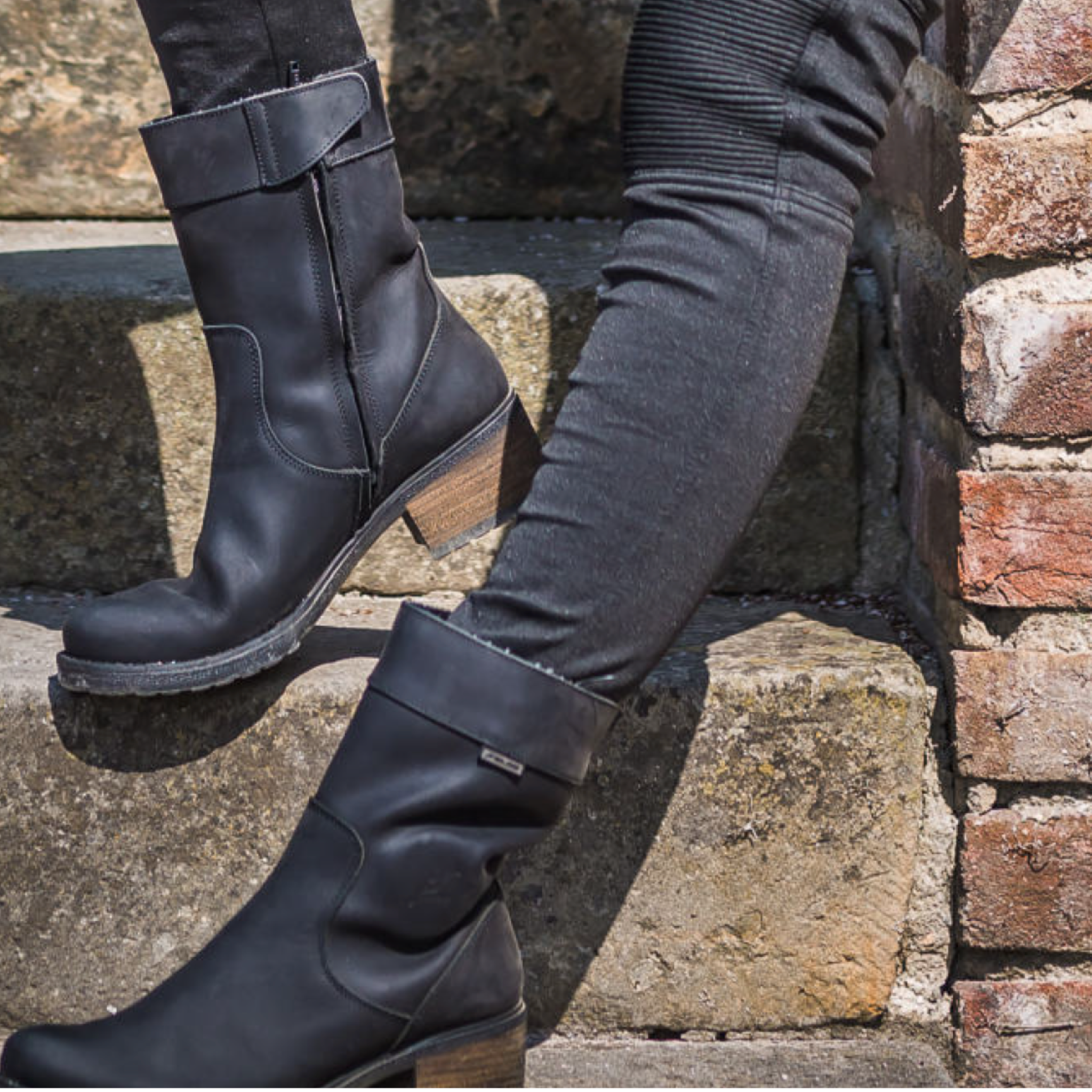 Woman&#39;s legs wearing black women&#39;s motorcycle boots from Falco 