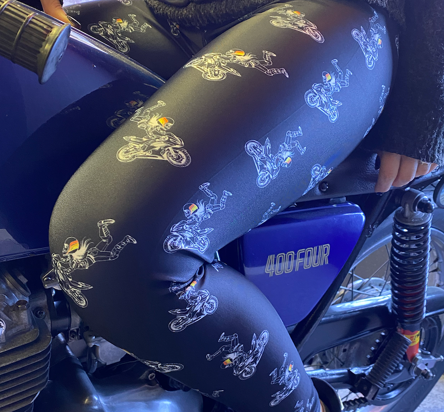 A close up of a woman&#39;s leg wearing leggings with motorcycle motives