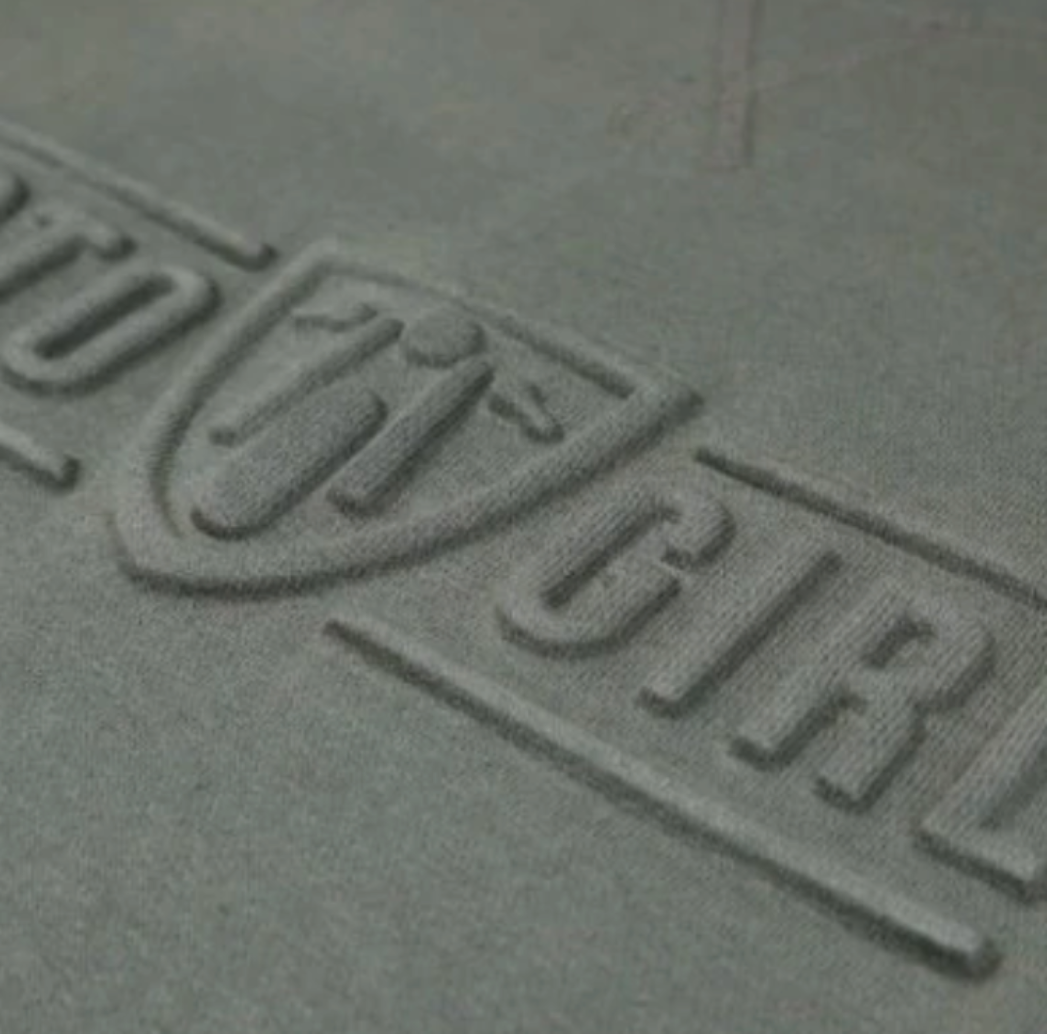 A close up of the 3d logo on a women's motorcycle sweatshirt from Moto Girl in the color olive green 