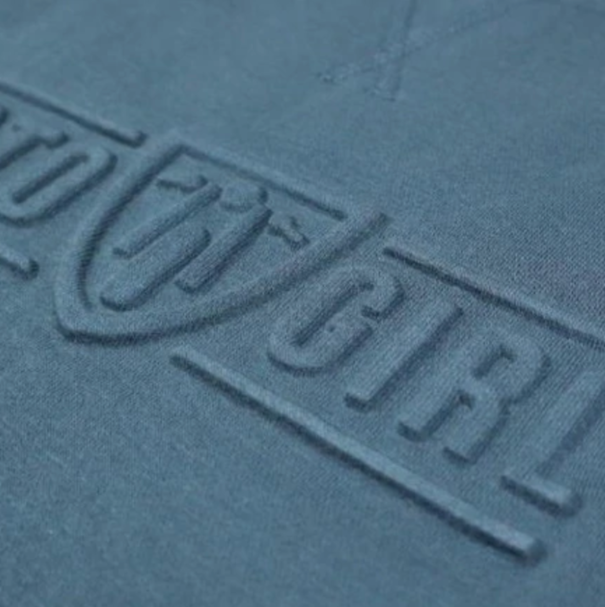 A close up of the 3d logo on a women's motorcycle sweatshirt from Moto Girl in dark blue