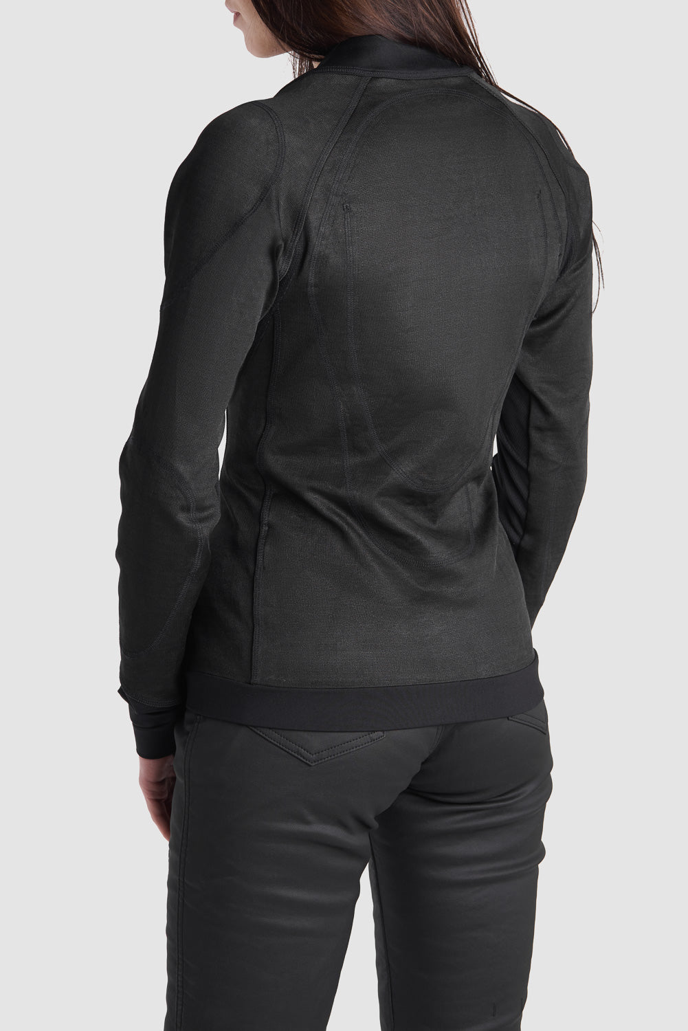 A women&#39;s, wearing black armoured motorcycle underwear top, back 